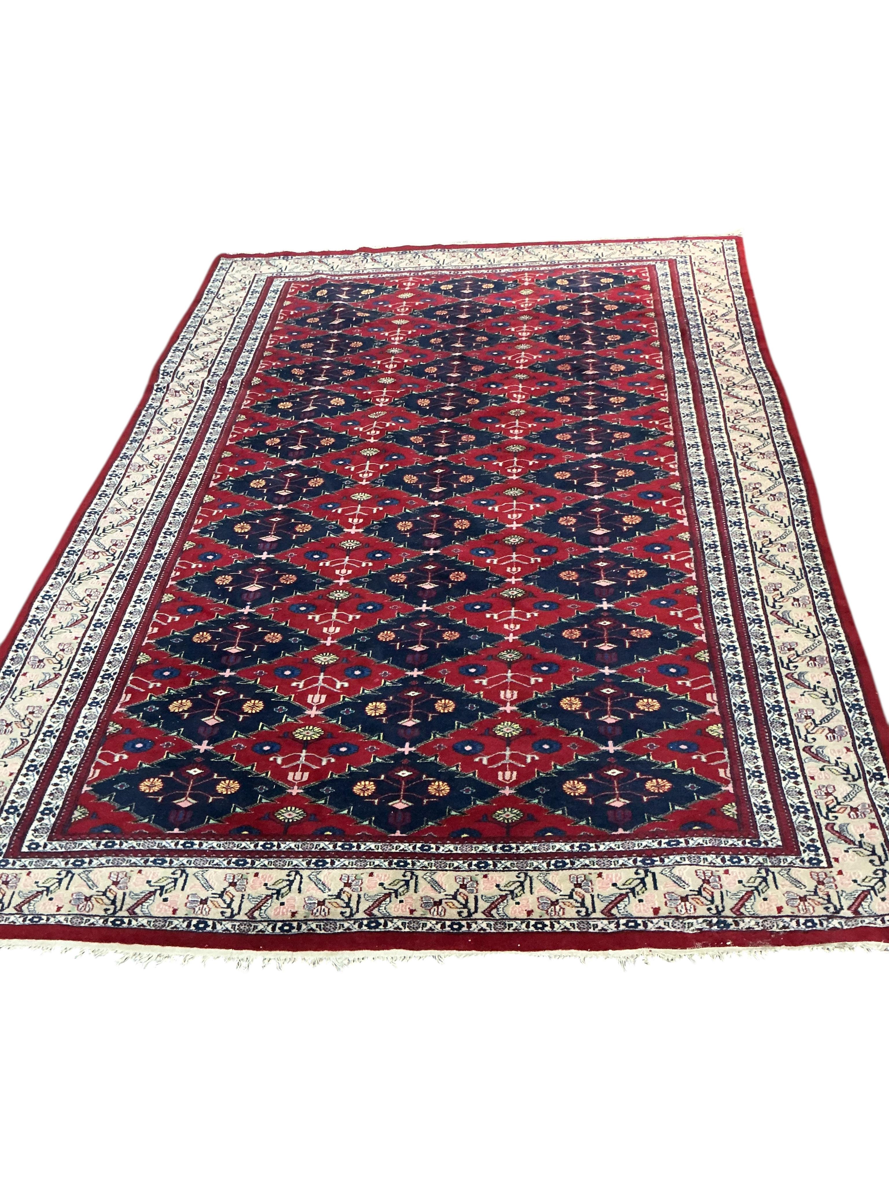 An Afghan red ground carpet, 270 x 188cm